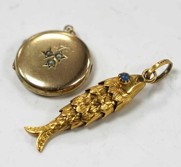 An Italian 750 yellow metal and two stone blue cabochon set articulated gold fish pendant, overall 46mm and a yellow metal and split pearl set circular locket. Condition - poor to fair